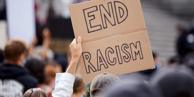 Private use of the k-word can still be hate speech, even if both parties are white oster with the words “End Racism”.